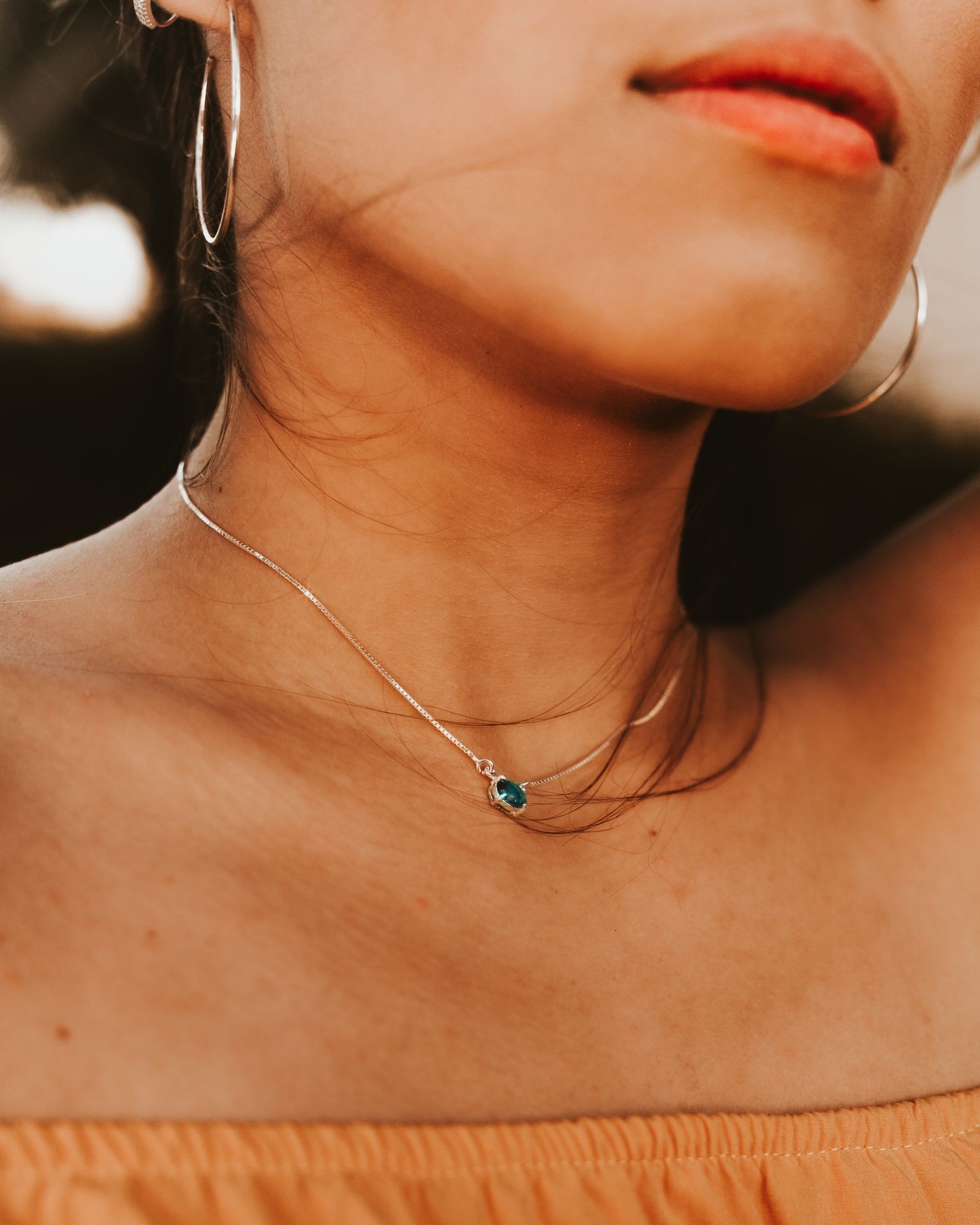 A delicate necklace worn close