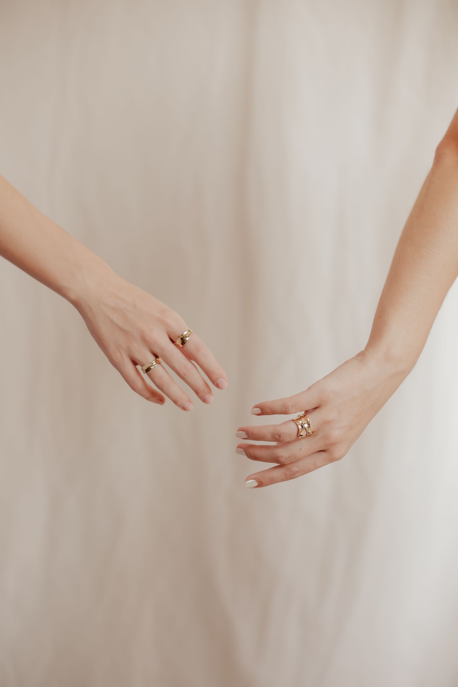 Two hands with stacked rings