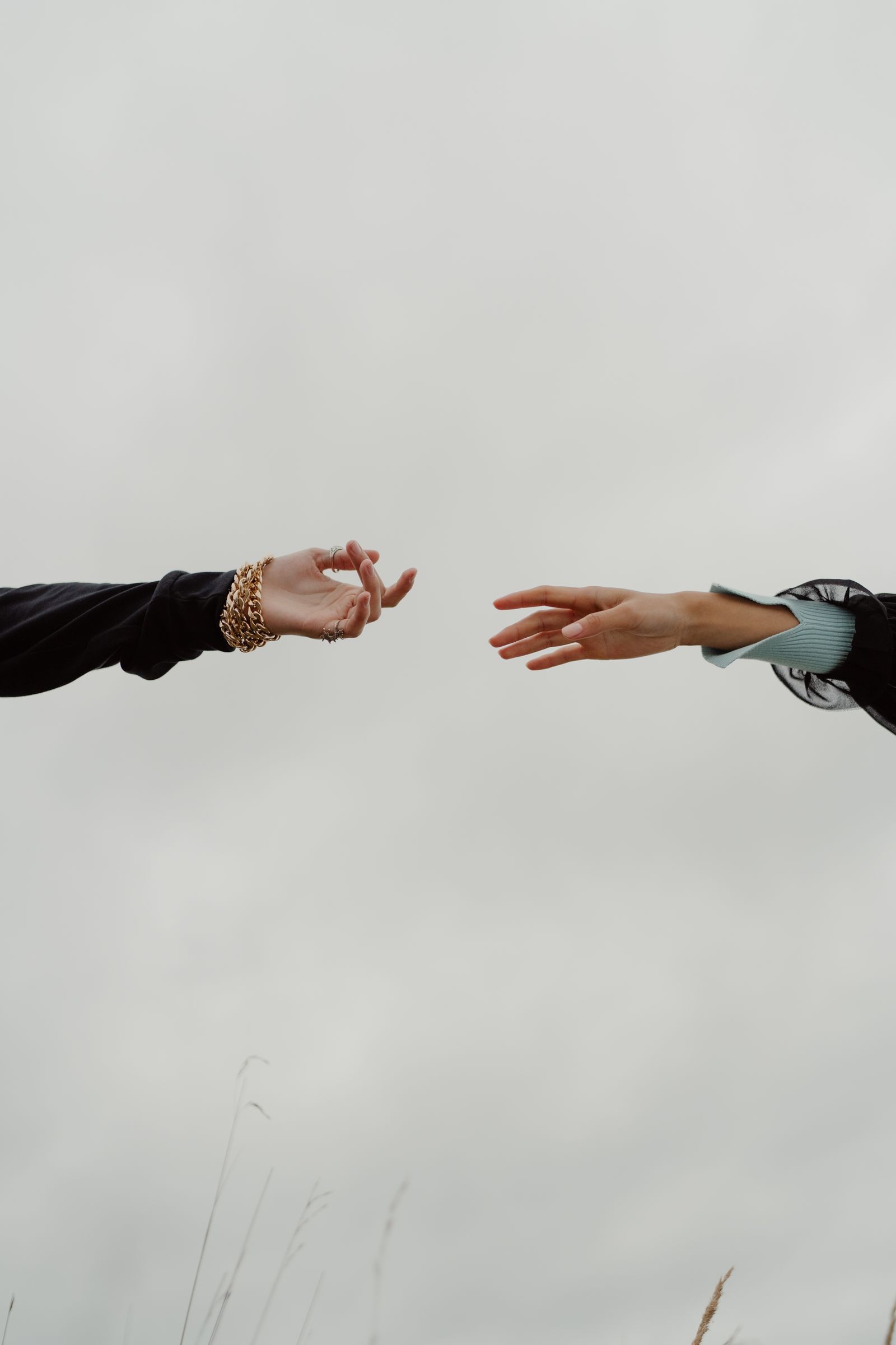 Two hands reaching towards each other