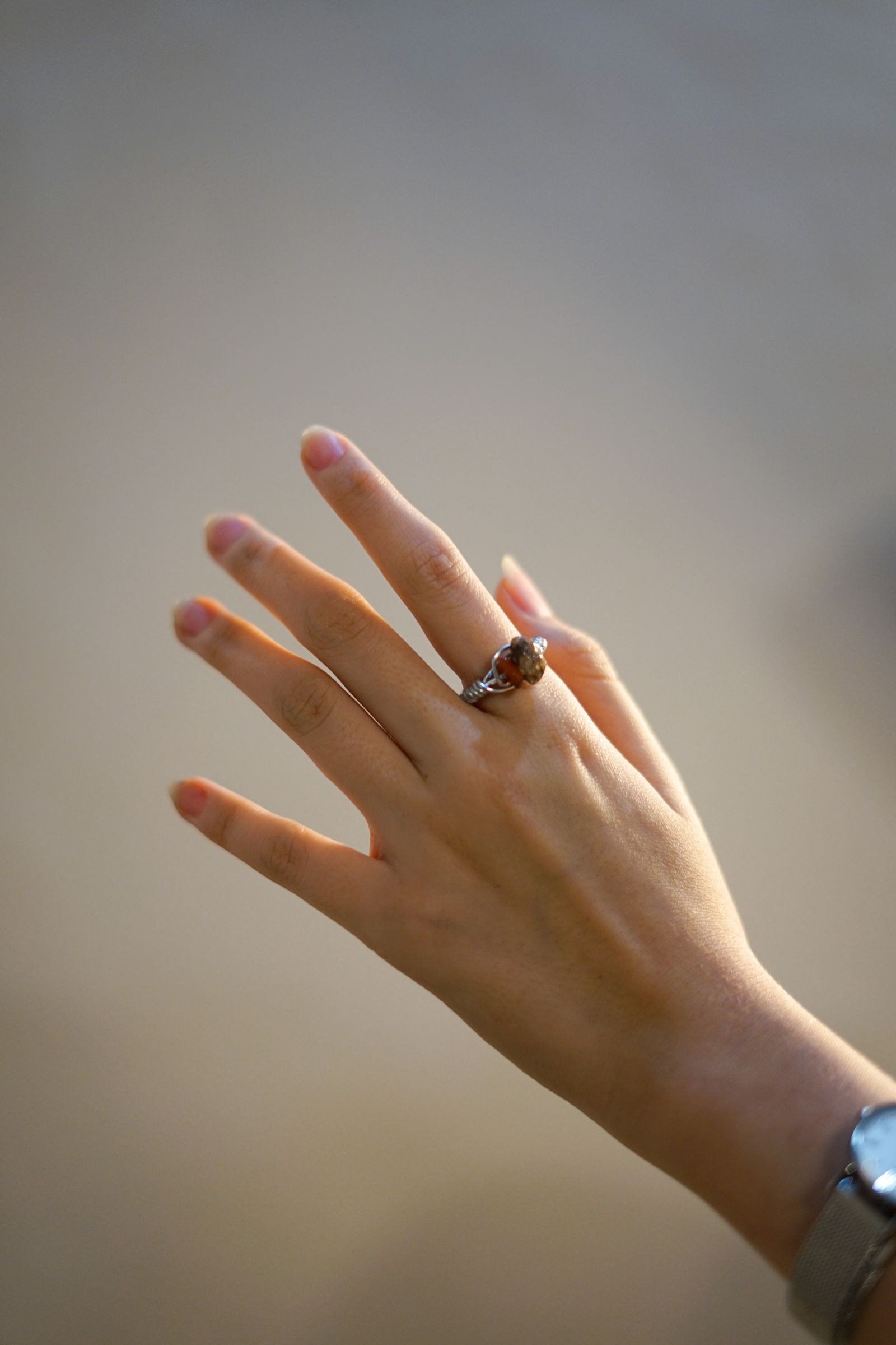 A hand wearing silver rings